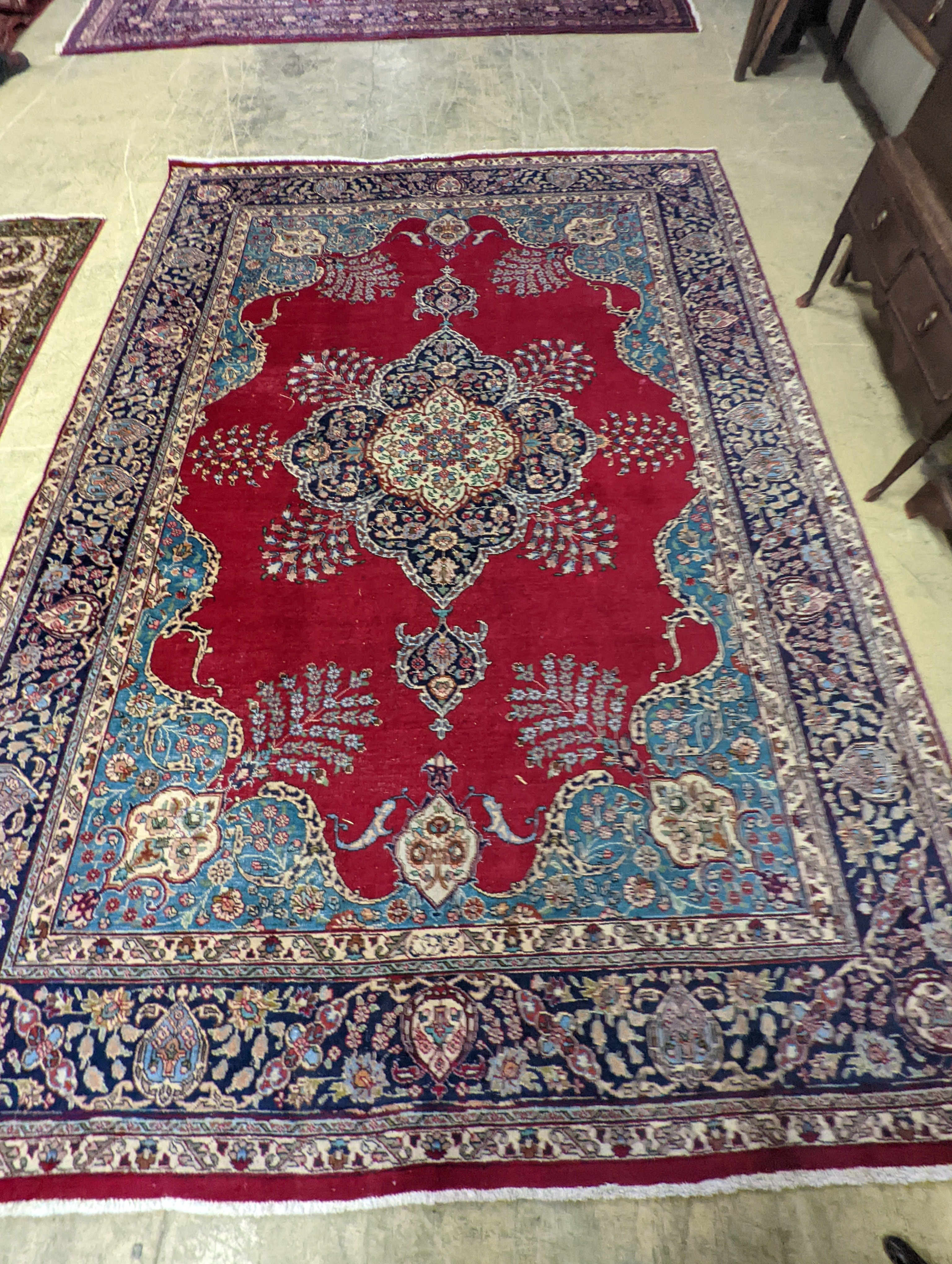 A Tabriz burgundy ground carpet, 350 x 240cm